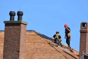 Two Men Repairing Roof at Citadel Hill - Timothy Parks Roofing & Construction Inc Two Men Repairing Roof at Citadel Hill