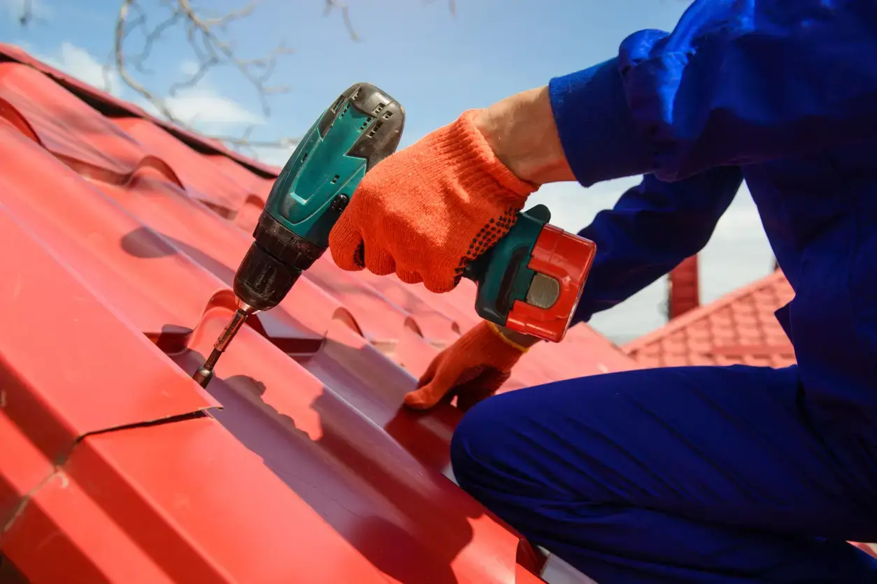 Close up hands in protective gloves of young man worker - Timothy Parks Roofing & Construction Inc Close up hands in protective gloves of young man worker